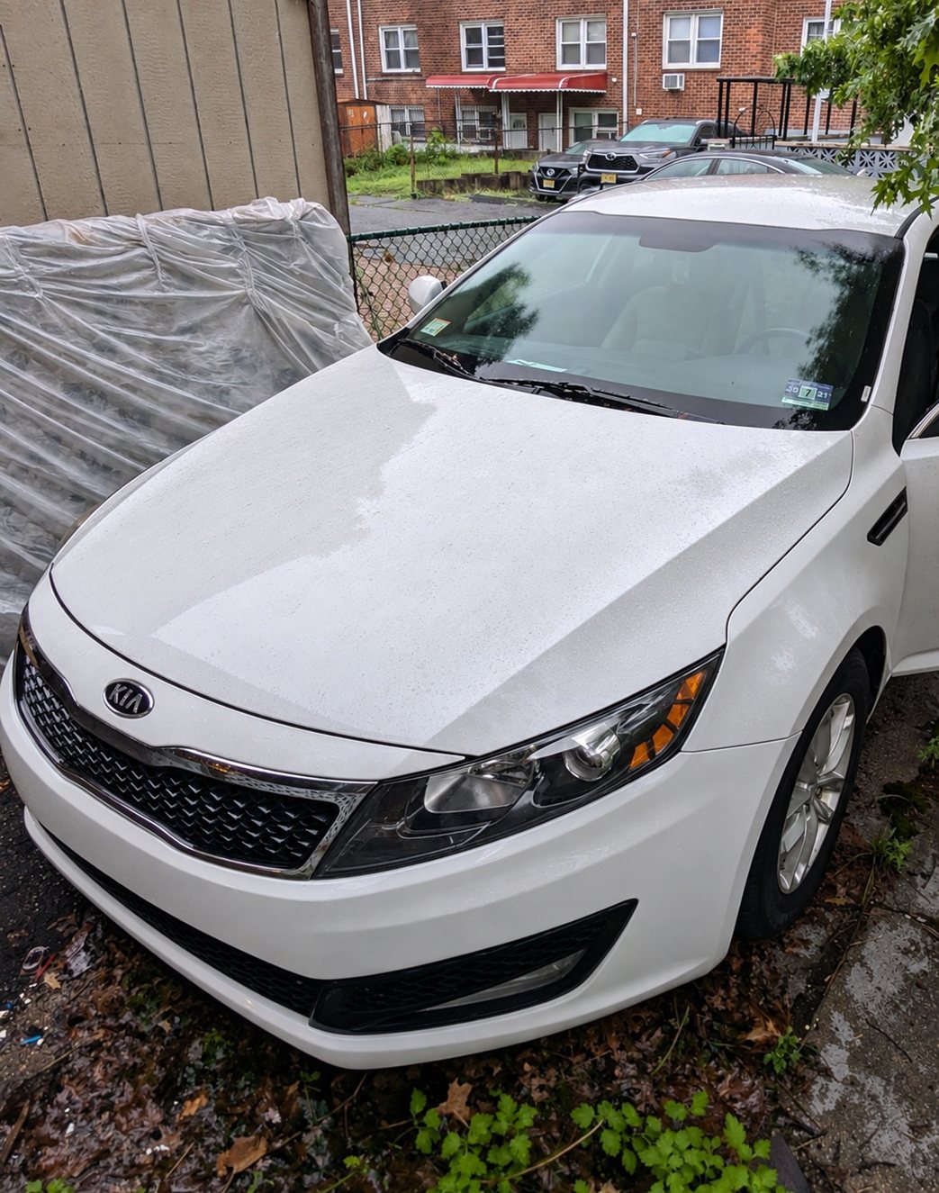 The same Kia with bumper, grille and headlight repaired